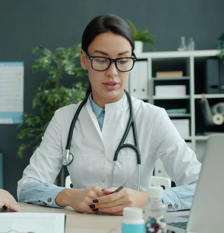 Doctor speaking attentively with an older patient in a consultation room